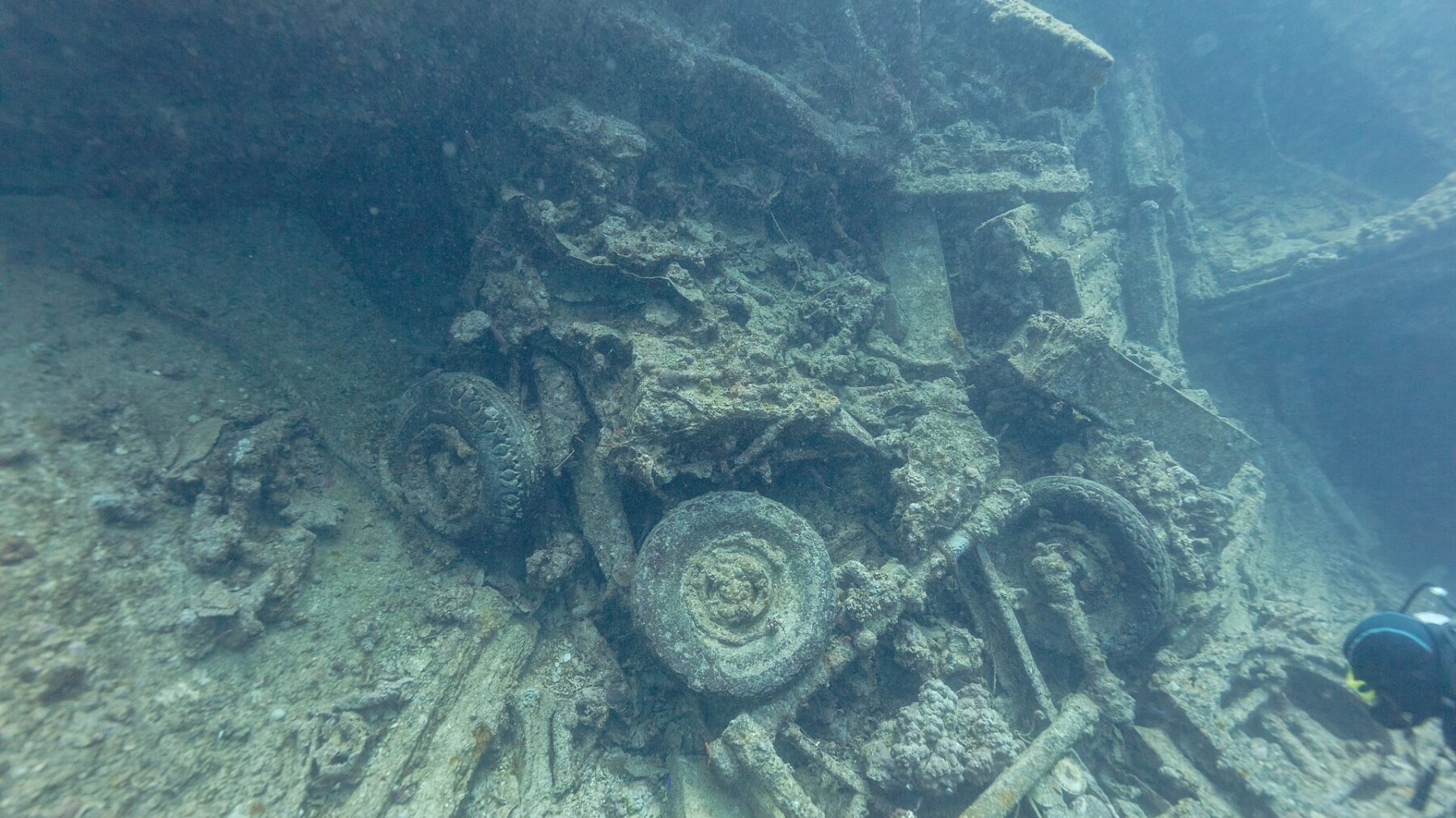 Divers and structure on the SS Thistlegorm wreck in the Red Sea.