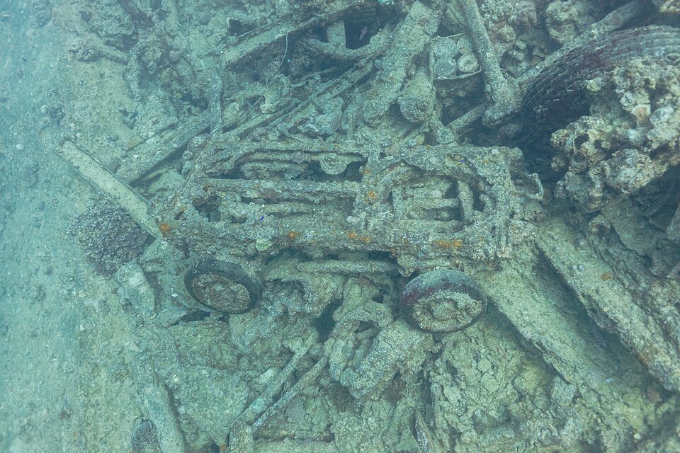 Vehicle frames and wheels among cargo on the SS Thistlegorm wreck.